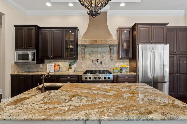 5909 Oxford Moor Blvd, Windermere, FL 34786 - kitchen featuring appliances with stainless steel finishes, a sink, a center island with sink, custom exhaust hood, and light stone counters