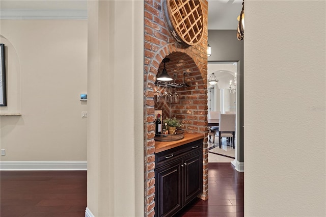 5909 Oxford Moor Blvd, Windermere, FL 34786 - corridor with dark wood finished floors, arched walkways, baseboards, and crown molding