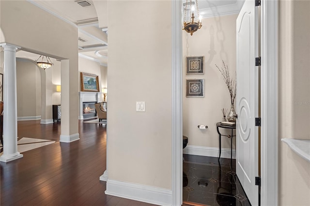 5909 Oxford Moor Blvd, Windermere, FL 34786 - corridor with ornate columns, crown molding, dark wood-type flooring, baseboards, and arched walkways