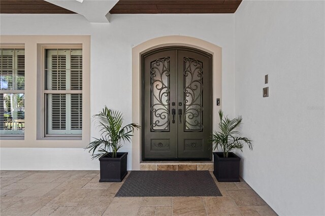 5909 Oxford Moor Blvd, Windermere, FL 34786 - property entrance with french doors and stucco siding