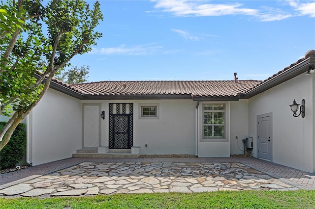 5909 Oxford Moor Blvd, Windermere, FL 34786 - back of property featuring a tiled roof, stucco siding, and a patio