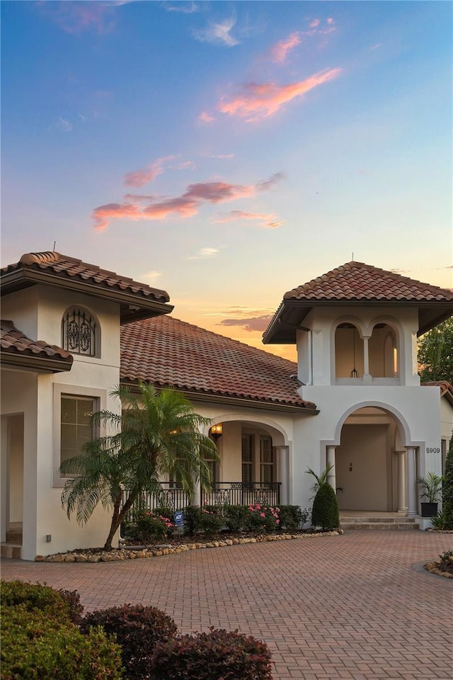 5909 Oxford Moor Blvd, Windermere, FL 34786 - mediterranean / spanish home with a tile roof, curved driveway, and stucco siding