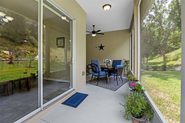 sunroom / solarium with a ceiling fan and healthy amount of natural light