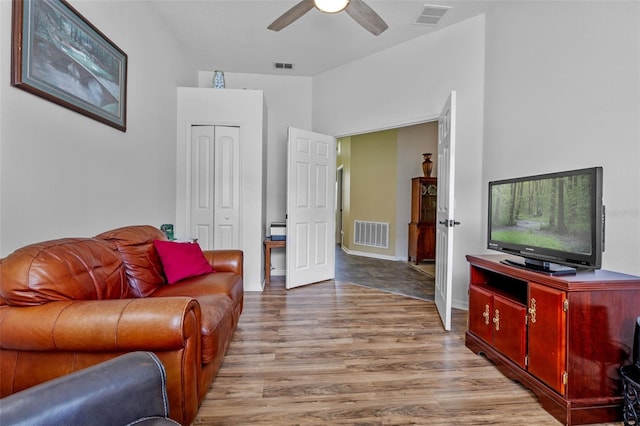 living room with wood finished floors and ceiling fan