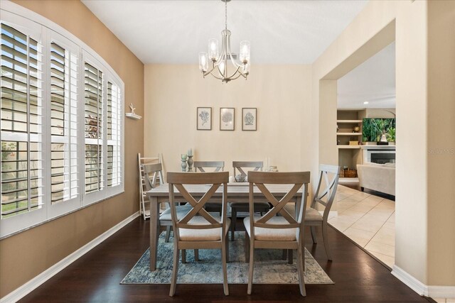 1428 Lucky Pennie Way, Apopka, FL 32712 - dining room with a chandelier, wood finished floors, baseboards, and built in features