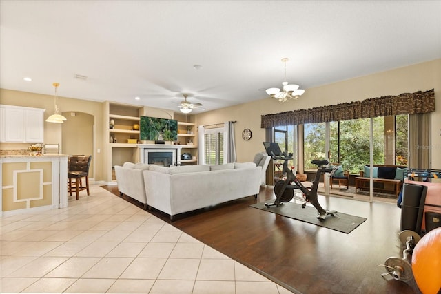 1428 Lucky Pennie Way, Apopka, FL 32712 - living area with light tile patterned floors, recessed lighting, a chandelier, ceiling fan, and a glass covered fireplace