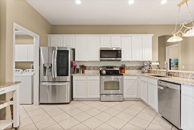 1428 Lucky Pennie Way, Apopka, FL 32712 - kitchen featuring stainless steel appliances, independent washer and dryer, a sink, white cabinets, and pendant lighting
