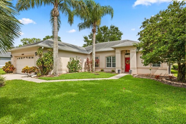 1428 Lucky Pennie Way, Apopka, FL 32712 - ranch-style house featuring stucco siding, an attached garage, a front lawn, and concrete driveway