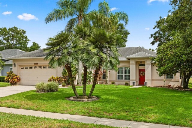 1428 Lucky Pennie Way, Apopka, FL 32712 - view of front facade with stucco siding, an attached garage, driveway, and a front yard