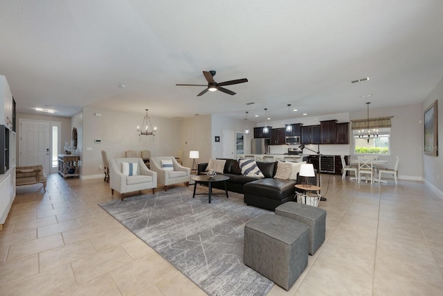 living area with a chandelier, ceiling fan, light tile patterned floors, baseboards, and recessed lighting