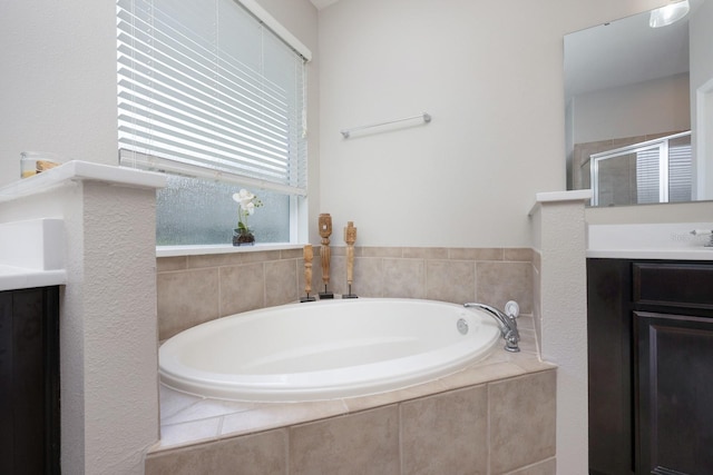bathroom with vanity, a shower stall, and a bath