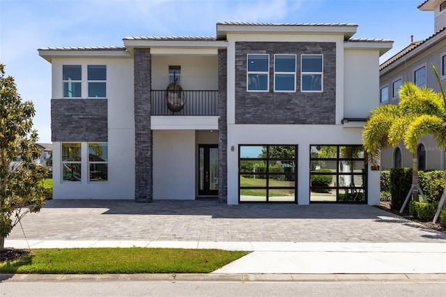 300 Muirfield Loop, Reunion, FL 34747 - view of front of home with stucco siding, a balcony, and a tiled roof