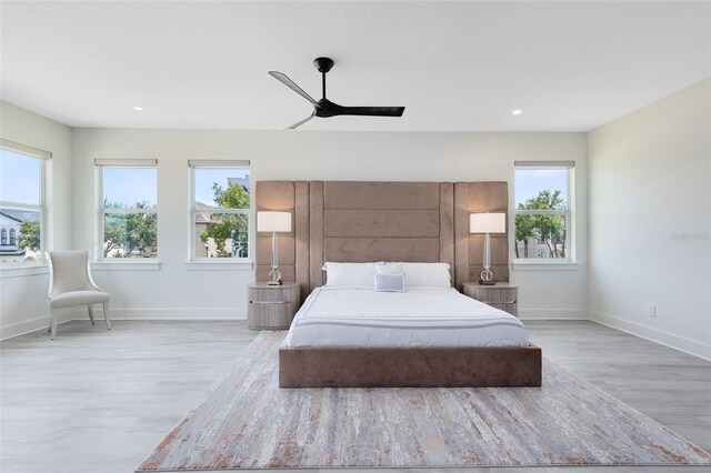 300 Muirfield Loop, Reunion, FL 34747 - bedroom featuring wood finished floors, baseboards, a ceiling fan, and recessed lighting