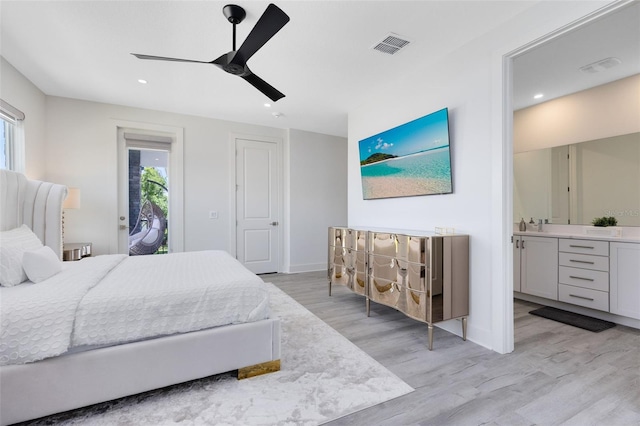 300 Muirfield Loop, Reunion, FL 34747 - bedroom featuring multiple windows, access to exterior, light wood-type flooring, recessed lighting, and ensuite bathroom