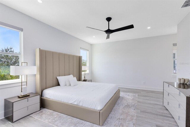 300 Muirfield Loop, Reunion, FL 34747 - bedroom with multiple windows, recessed lighting, light wood-style flooring, ceiling fan, and baseboards