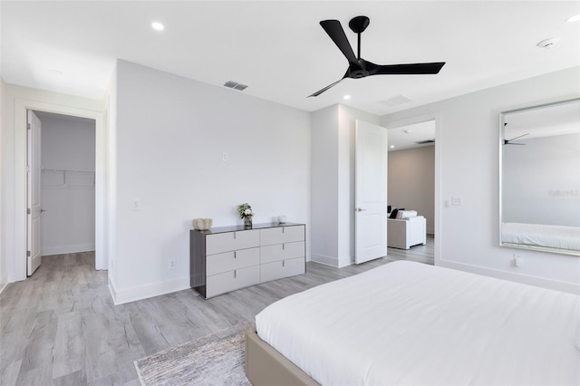 300 Muirfield Loop, Reunion, FL 34747 - bedroom with light wood-style flooring, baseboards, a spacious closet, a ceiling fan, and recessed lighting