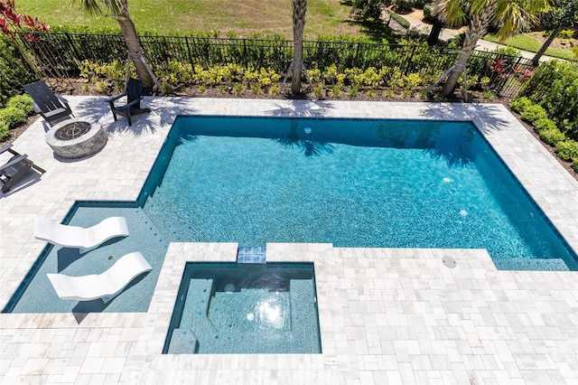 300 Muirfield Loop, Reunion, FL 34747 - view of pool featuring an outdoor fire pit, a patio, a fenced backyard, and a pool with connected hot tub