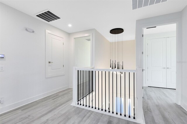 300 Muirfield Loop, Reunion, FL 34747 - corridor featuring wood finished floors, an upstairs landing, baseboards, and recessed lighting