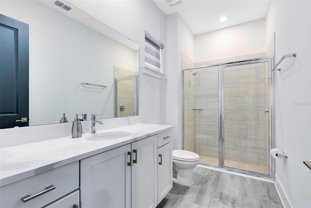 300 Muirfield Loop, Reunion, FL 34747 - bathroom with a shower stall, wood finished floors, toilet, and vanity