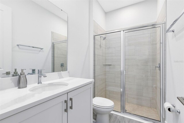 300 Muirfield Loop, Reunion, FL 34747 - bathroom with a stall shower, toilet, and vanity