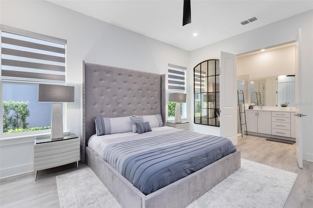 300 Muirfield Loop, Reunion, FL 34747 - bedroom with light wood-type flooring, baseboards, ensuite bathroom, and recessed lighting