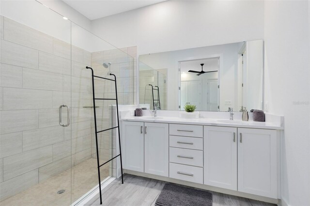 300 Muirfield Loop, Reunion, FL 34747 - full bath featuring a shower stall, ceiling fan, double vanity, and wood finished floors