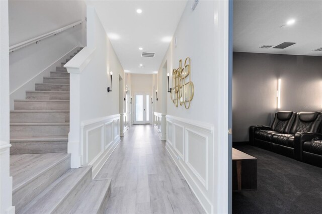 300 Muirfield Loop, Reunion, FL 34747 - corridor with stairway, wainscoting, recessed lighting, a decorative wall, and wood finished floors