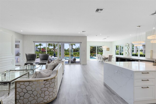 300 Muirfield Loop, Reunion, FL 34747 - living area featuring light wood-style flooring, recessed lighting, and french doors