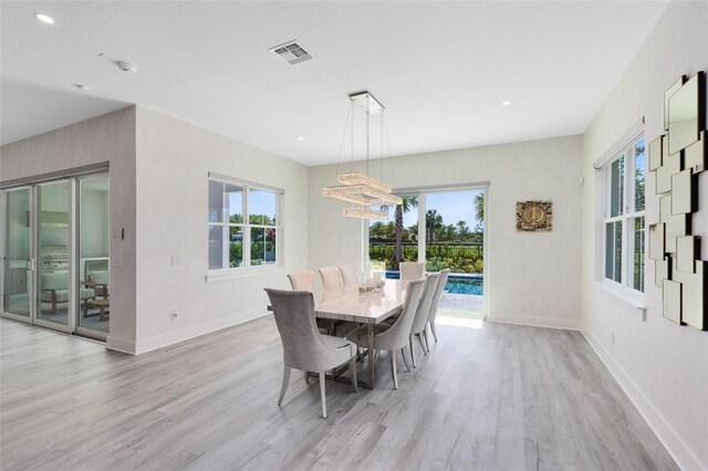 300 Muirfield Loop, Reunion, FL 34747 - dining room featuring light wood finished floors, plenty of natural light, baseboards, and recessed lighting