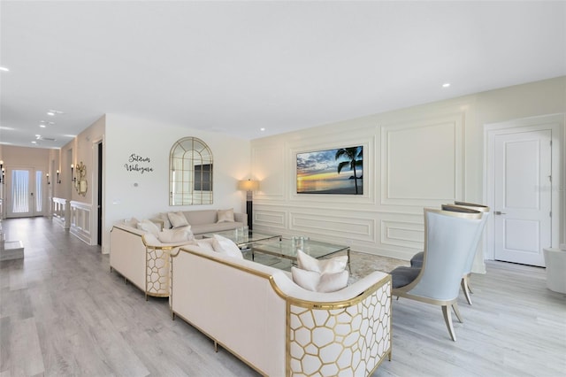 300 Muirfield Loop, Reunion, FL 34747 - living area featuring light wood-style flooring, a decorative wall, and recessed lighting