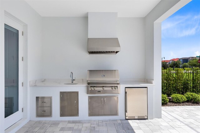 300 Muirfield Loop, Reunion, FL 34747 - view of patio featuring a grill, a sink, and exterior kitchen