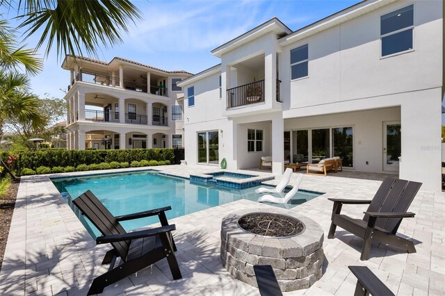 300 Muirfield Loop, Reunion, FL 34747 - view of pool featuring a patio area, an outdoor living space with a fire pit, and a pool with connected hot tub