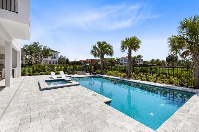 300 Muirfield Loop, Reunion, FL 34747 - view of pool with a patio area, fence, and a pool with connected hot tub