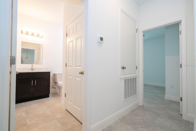 15998 SW 33rd Avenue Rd, Ocala, FL 34473 - hall with light tile patterned floors, baseboards, visible vents, and a sink