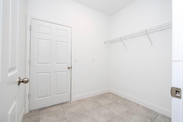 15998 SW 33rd Avenue Rd, Ocala, FL 34473 - laundry room with baseboards, laundry area, and light tile patterned floors