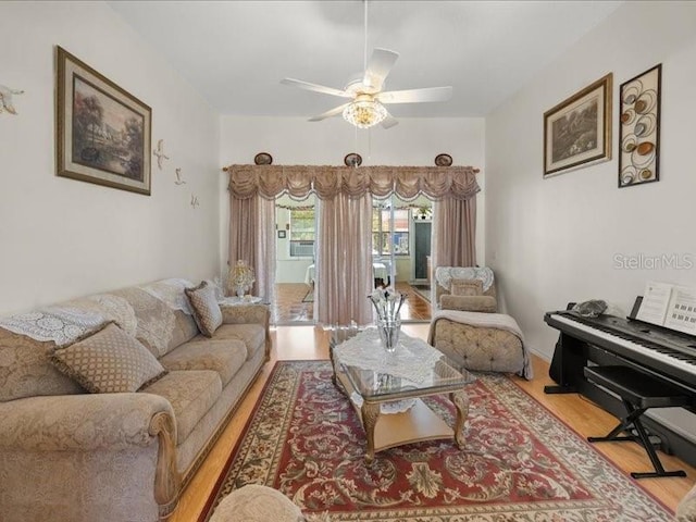 living room featuring light wood-type flooring and ceiling fan