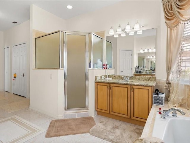full bathroom featuring a shower stall, vanity, a garden tub, and tile patterned flooring