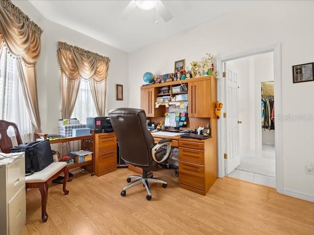 office space with light wood-type flooring and ceiling fan