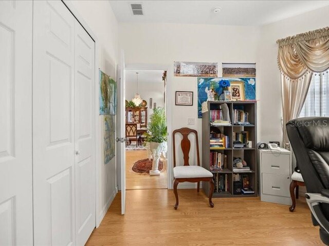 living area featuring light wood-style flooring and a desk