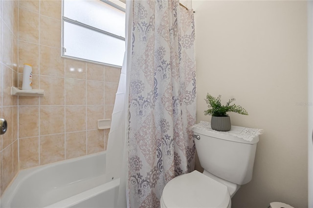 full bathroom featuring toilet and shower / bath combination with curtain