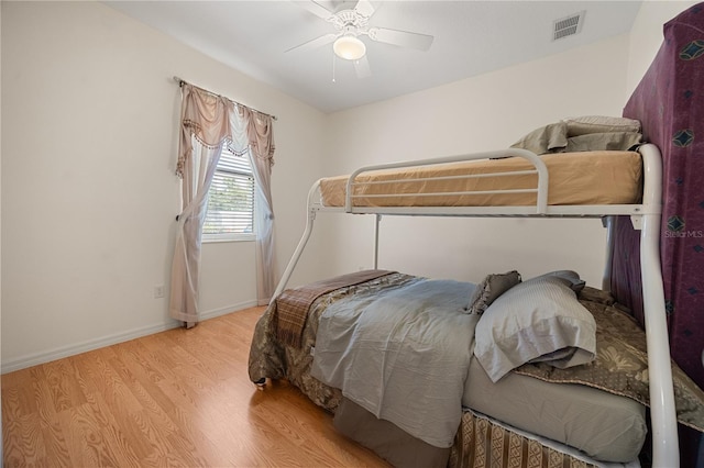 bedroom with wood finished floors, ceiling fan, and baseboards