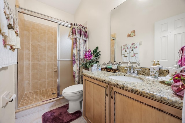 bathroom with tile patterned flooring, a shower stall, toilet, and vanity