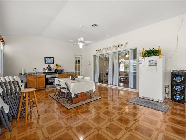 dining room with vaulted ceiling and ceiling fan