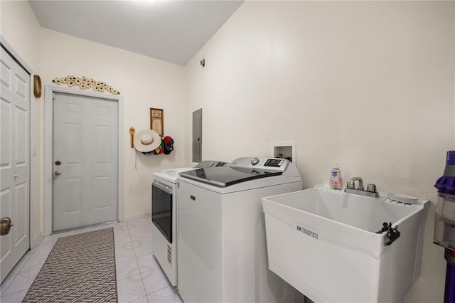 clothes washing area featuring washing machine and clothes dryer and electric panel