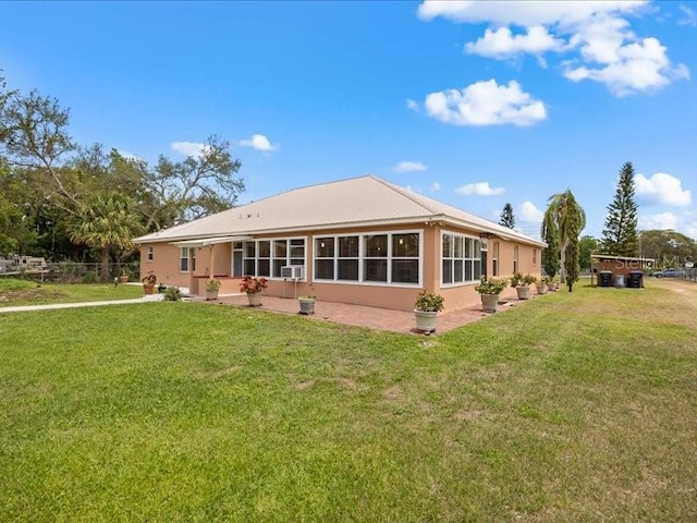 rear view of house featuring a lawn