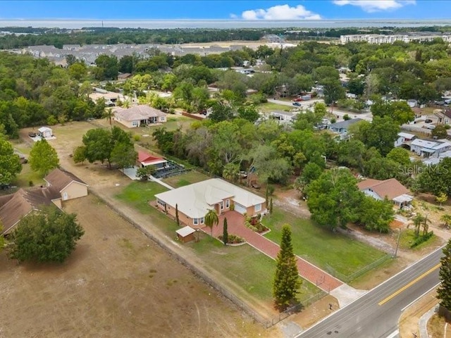 aerial perspective of suburban area featuring a tree filled landscape