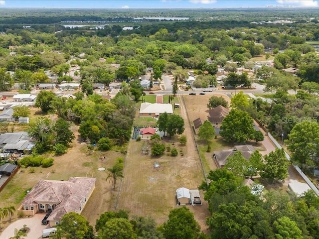 aerial view of property and surrounding area featuring nearby suburban area