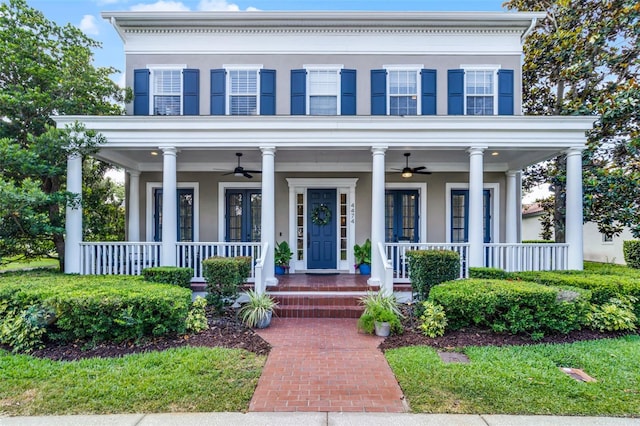 view of front of house featuring a ceiling fan, covered porch, and stucco siding
