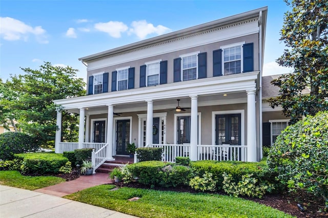 neoclassical / greek revival house with a ceiling fan, covered porch, french doors, and stucco siding