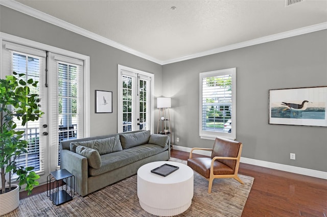 living area featuring french doors, healthy amount of natural light, crown molding, wood finished floors, and baseboards